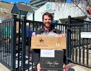 A Humanity in Practice volunteer dropping off donations at the Calgary Urban Projects Society's childcare centre.