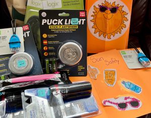 A collection of items gathered by HIP volunteers that help keep children safe - night reflectors, whistles, solar garden stakes (to light up their front porch), reflective vests, stickers, shoelaces, etc.