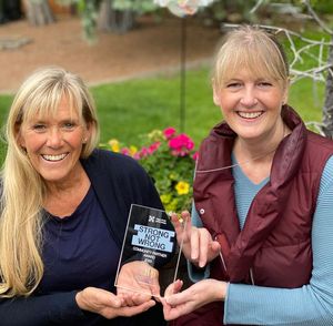 Marnie and Janica, HIP founders, holding their Strong Not Wrong Community Partner Award